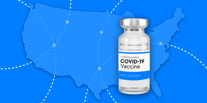 COVID-19 Vaccine bottle with US blue background.