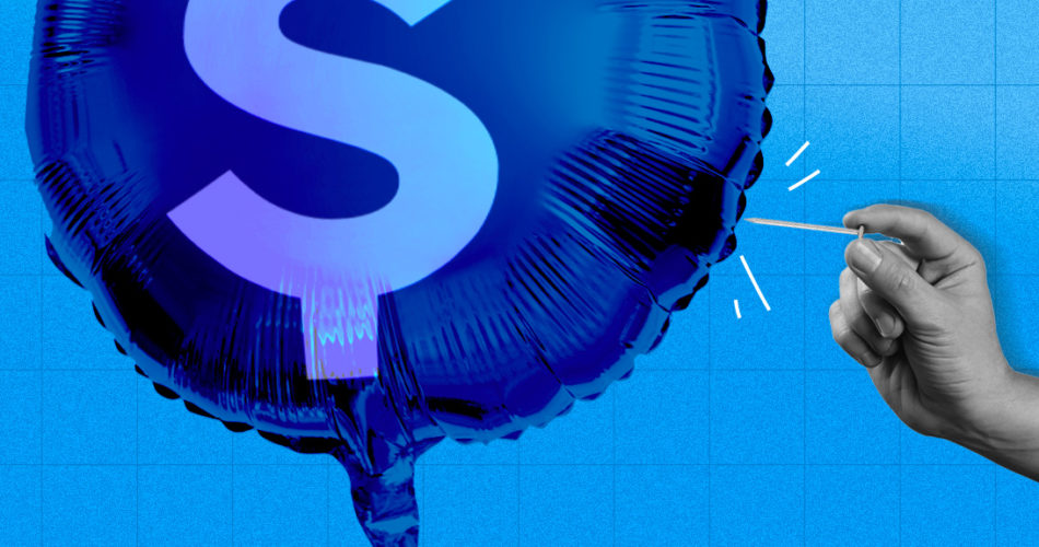 A hand popping a balloon with a money sign on it